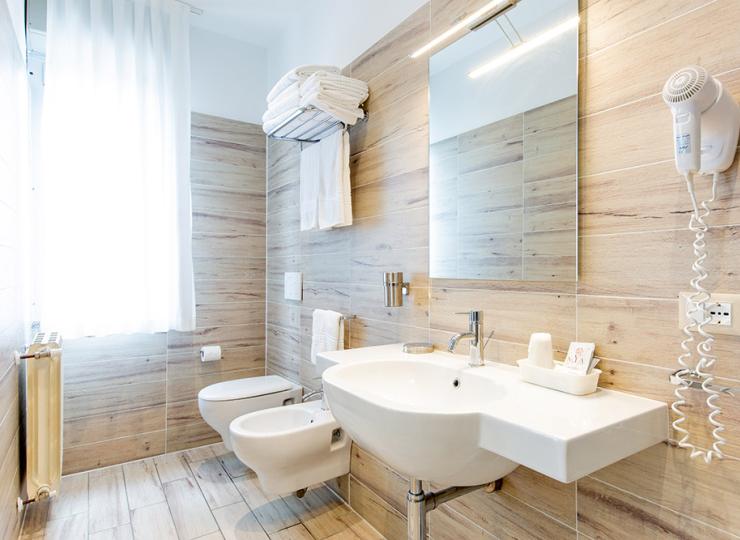 Modernes Badezimmer mit Holzfliesen, Spiegel und Haartrockner.